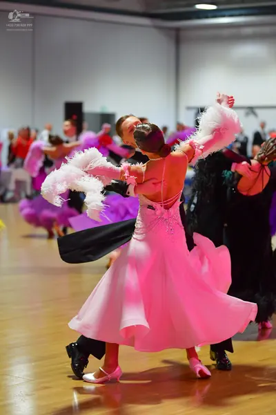 Dancesport competitor: Main female dancer: light pink ballroom dress with a shimmering bodice and large