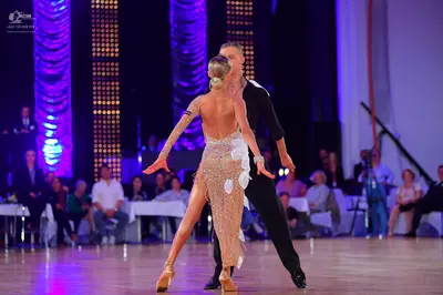 Dancesport competitor: Male dancer: black long-sleeved shirt and black trousers