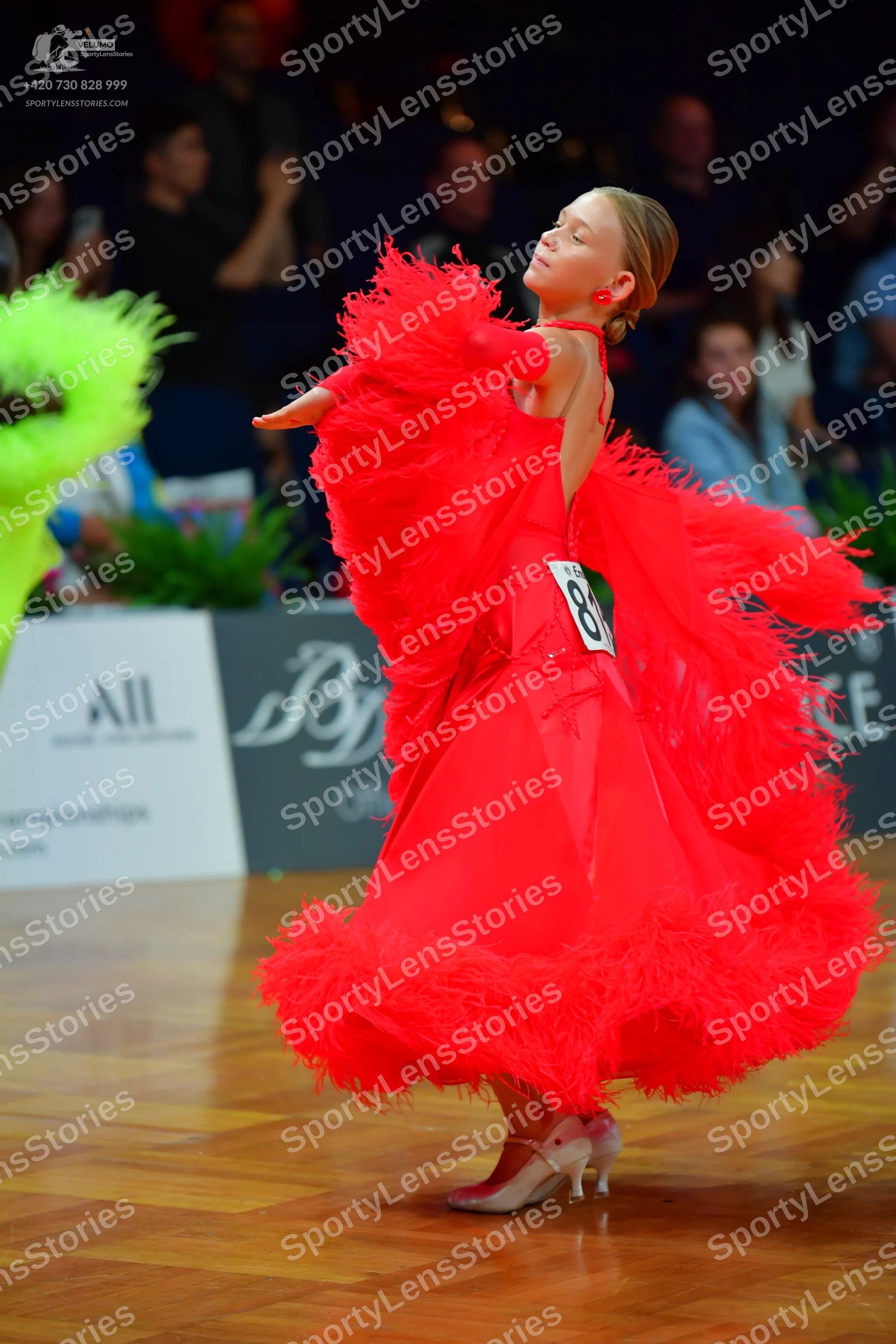 Dancesport competitor #84: Female dancer: red latin dress with voluminous red feathers/ruffles and red earr