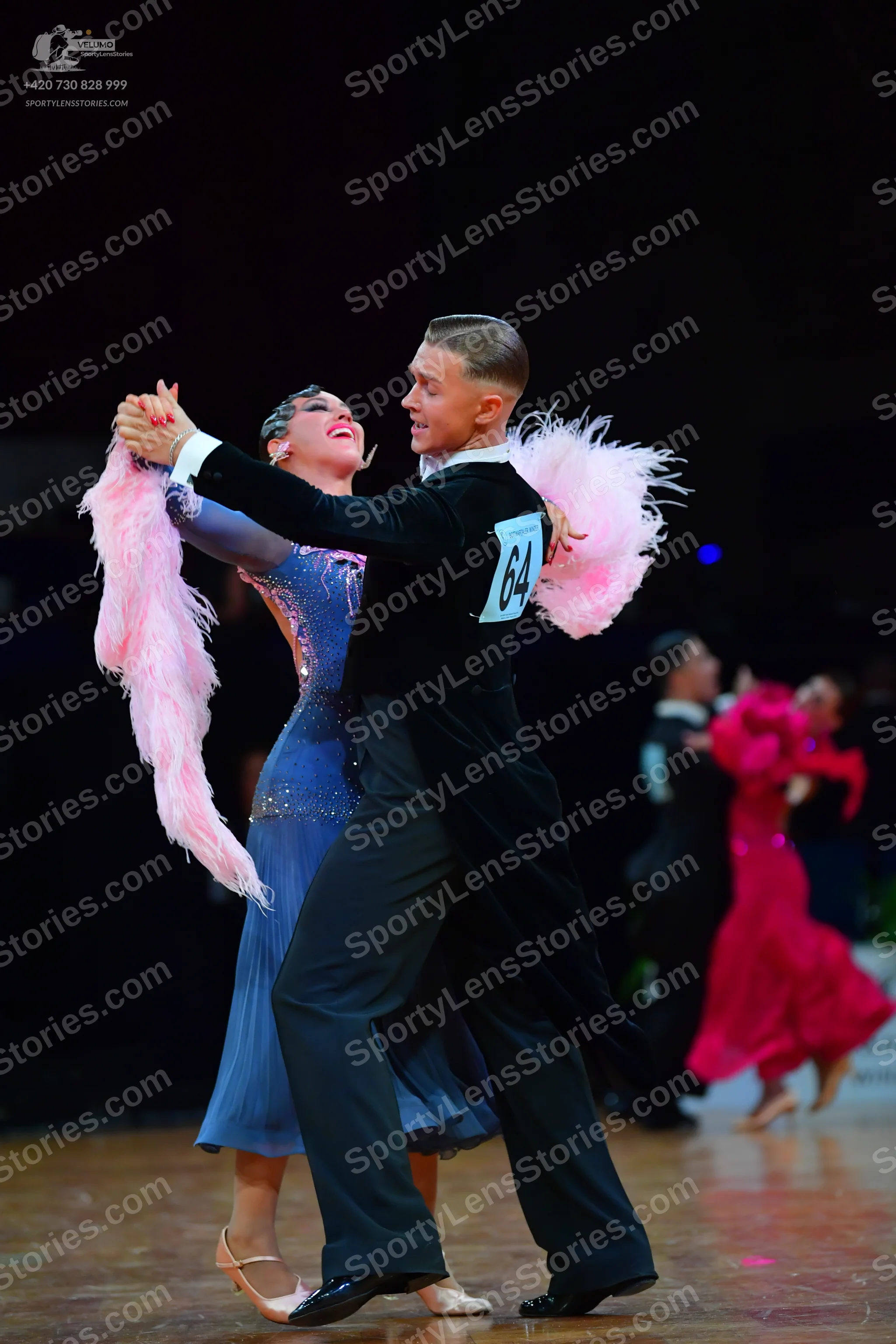 Dancesport competitor #64: Male dancer in foreground: black suit