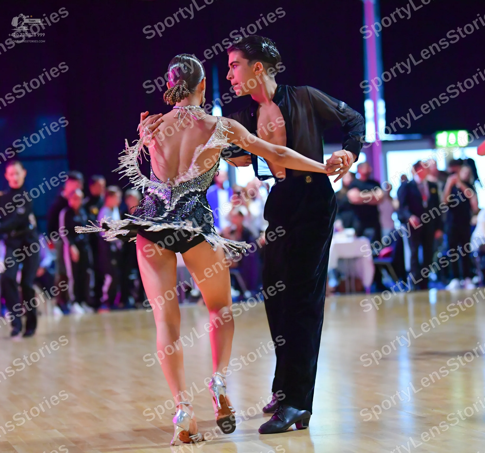 Dancesport competitor: Female dancer: silver and black latin dance costume heavily embellished with seq