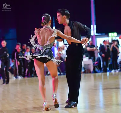 Dancesport competitor: Female dancer: silver and black latin dance costume heavily embellished with seq