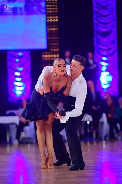 Dancesport competitor: Male dancer: white long-sleeved shirt and black trousers