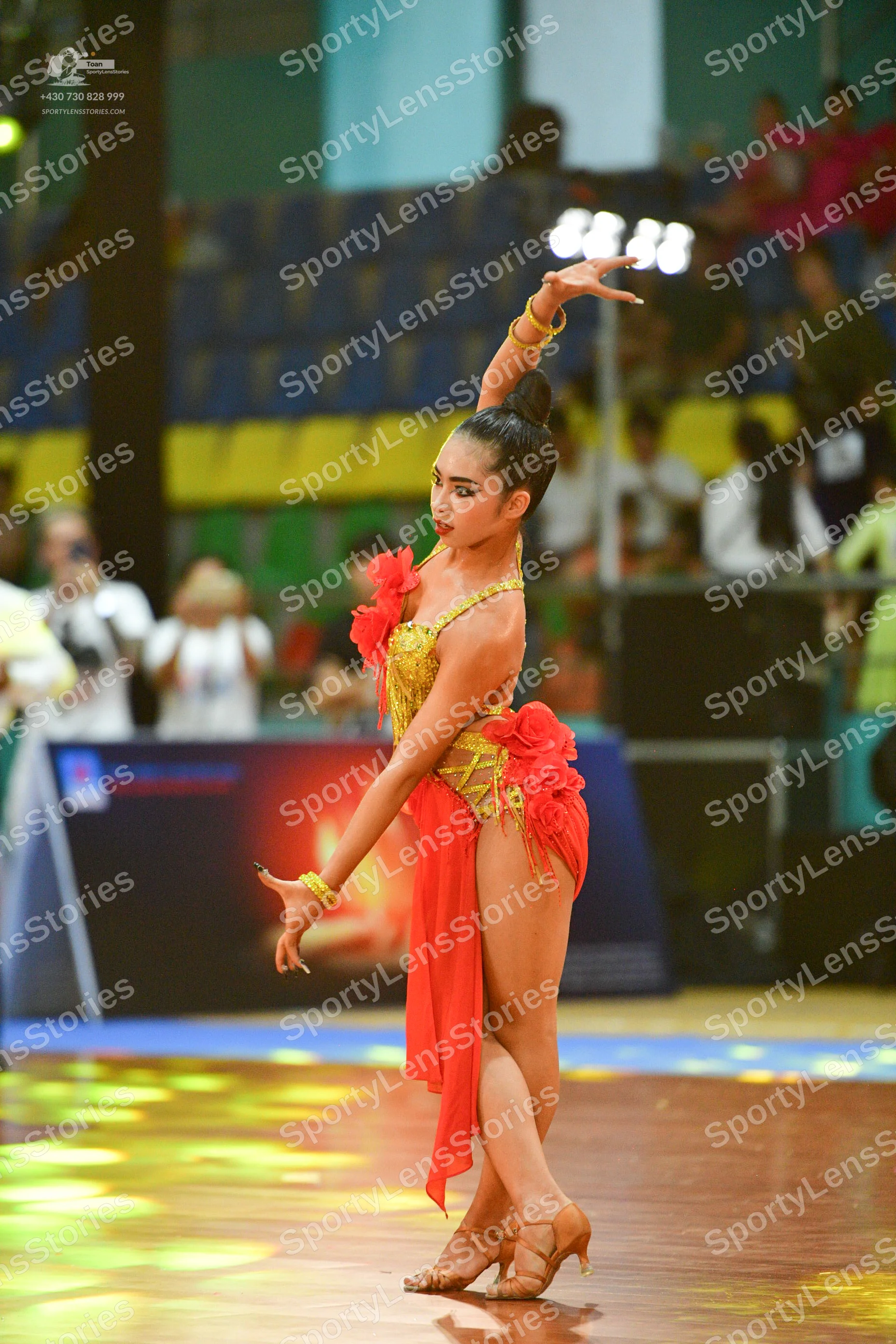 Dancesport competitor: ** Red Latin Dress
*   **Color:** Primarily vibrant red