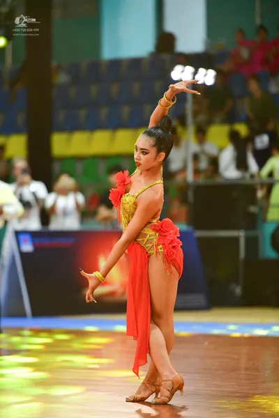 Dancesport competitor: ** Red Latin Dress
*   **Color:** Primarily vibrant red