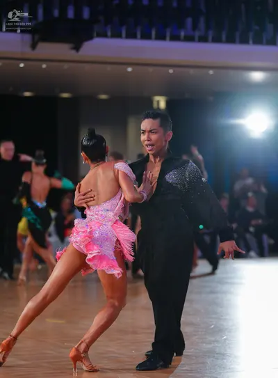 Dancesport competitor: Female dancer: pink sequined latin dress with fringe