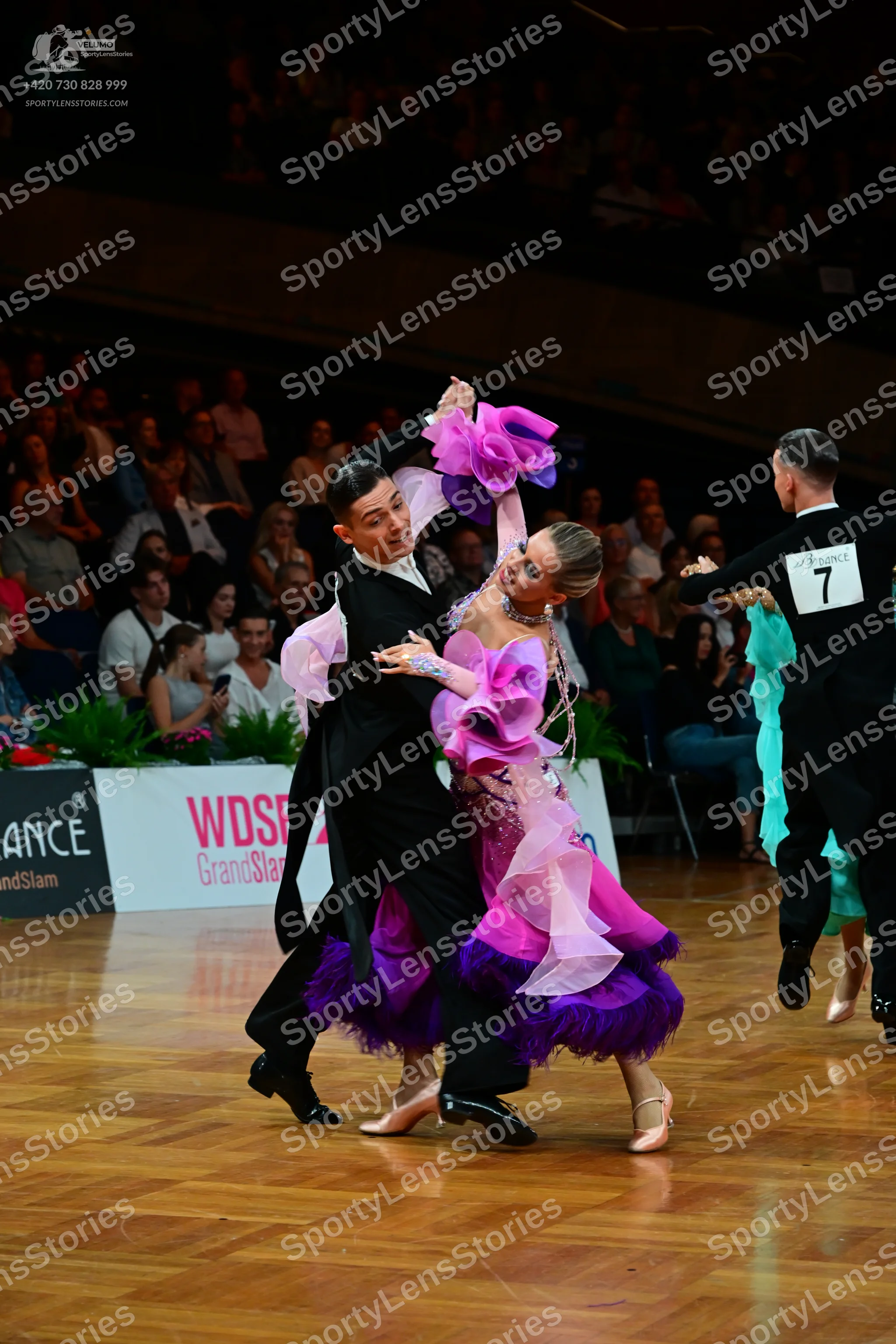 Dancesport competitor: Male dancer (left): black long-sleeve shirt and black trousers