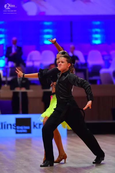 Dancesport competitor: Male dancer: black satin long-sleeved shirt and black trousers