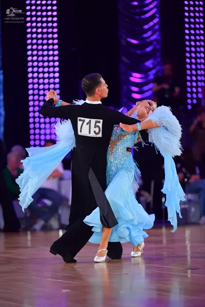 Dancesport competitor #715: Male dancer: black long-sleeved shirt with a white collar and black trousers