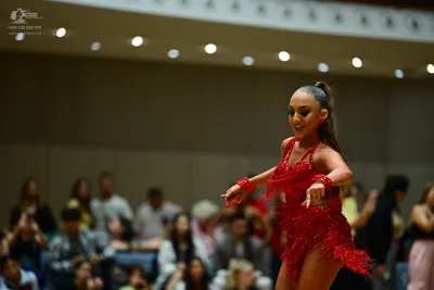 Dancesport competitor: Female dancer: red latin dress with fringe