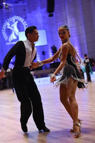 Dancesport competitor: Male dancer: black long-sleeved shirt with a large, sparkly white sequined front