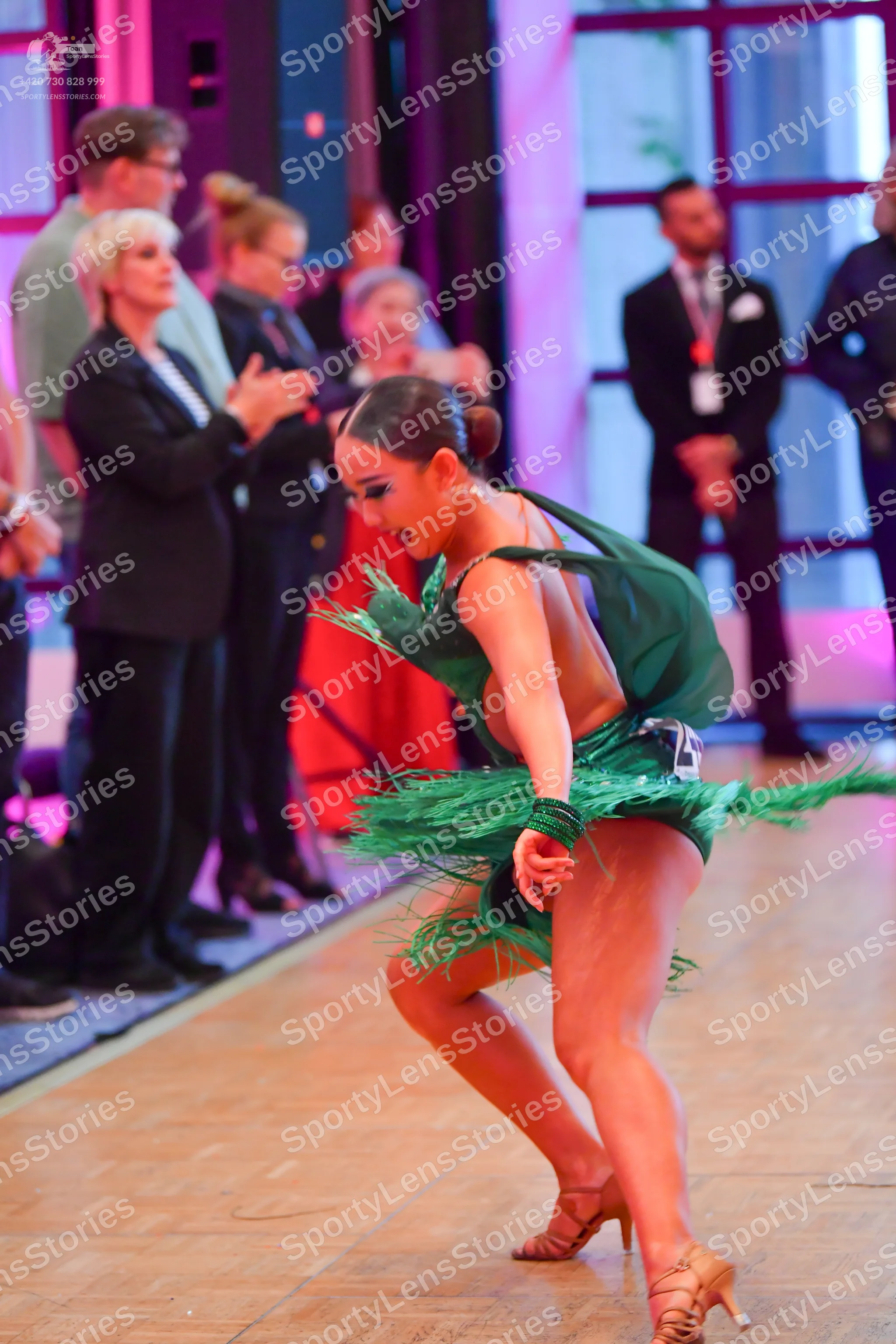 Dancesport competitor: Female dancer: green Latin dress with fringe