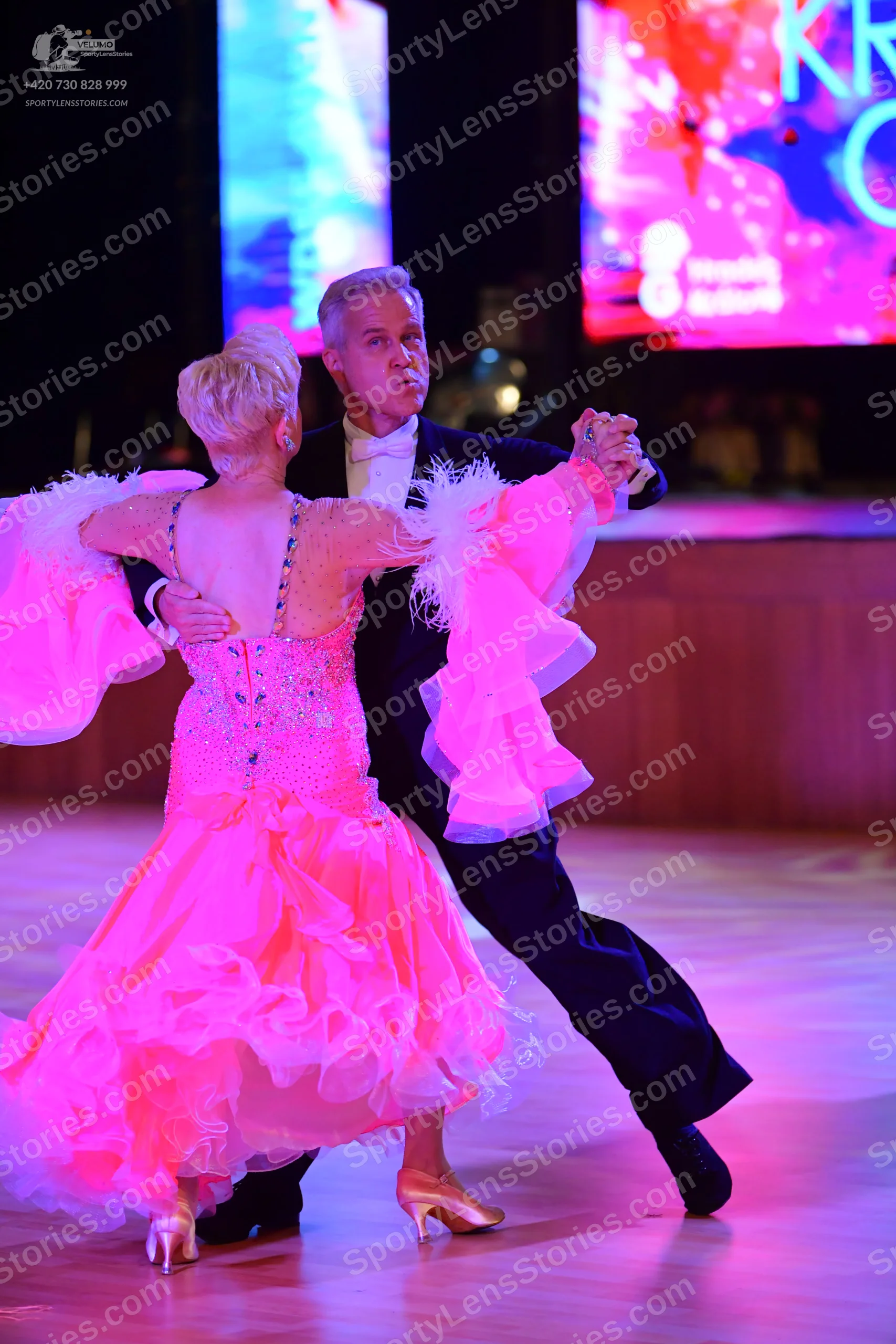 Dancesport competitor: Male:**
*   **Color:** Black
*   **Fabric:** Sequined (the suit is heavily embel