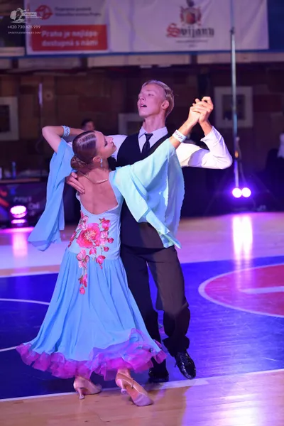 Dancesport competitor: Male dancer: white long-sleeved shirt, black waistcoat, black necktie, and black