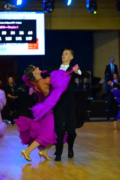 Dancesport competitor: Male dancer: black suit with white shirt and black bow tie