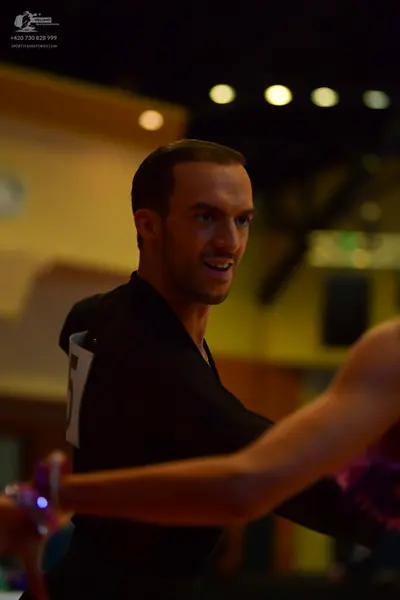 Dancesport competitor: Male dancer: black long-sleeved top