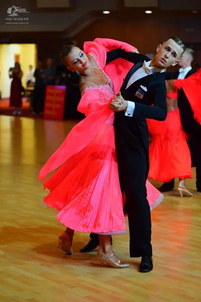 Dancesport competitor: Male dancer: black suit with a white shirt and a black bow tie