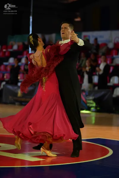 Dancesport competitor: Male dancer: black suit with a white shirt and white bow tie