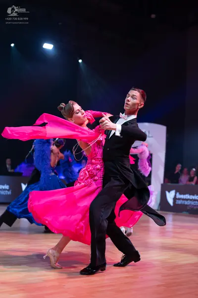 Dancesport competitor: Male dancer: black suit, white shirt, white bow tie, and black trousers