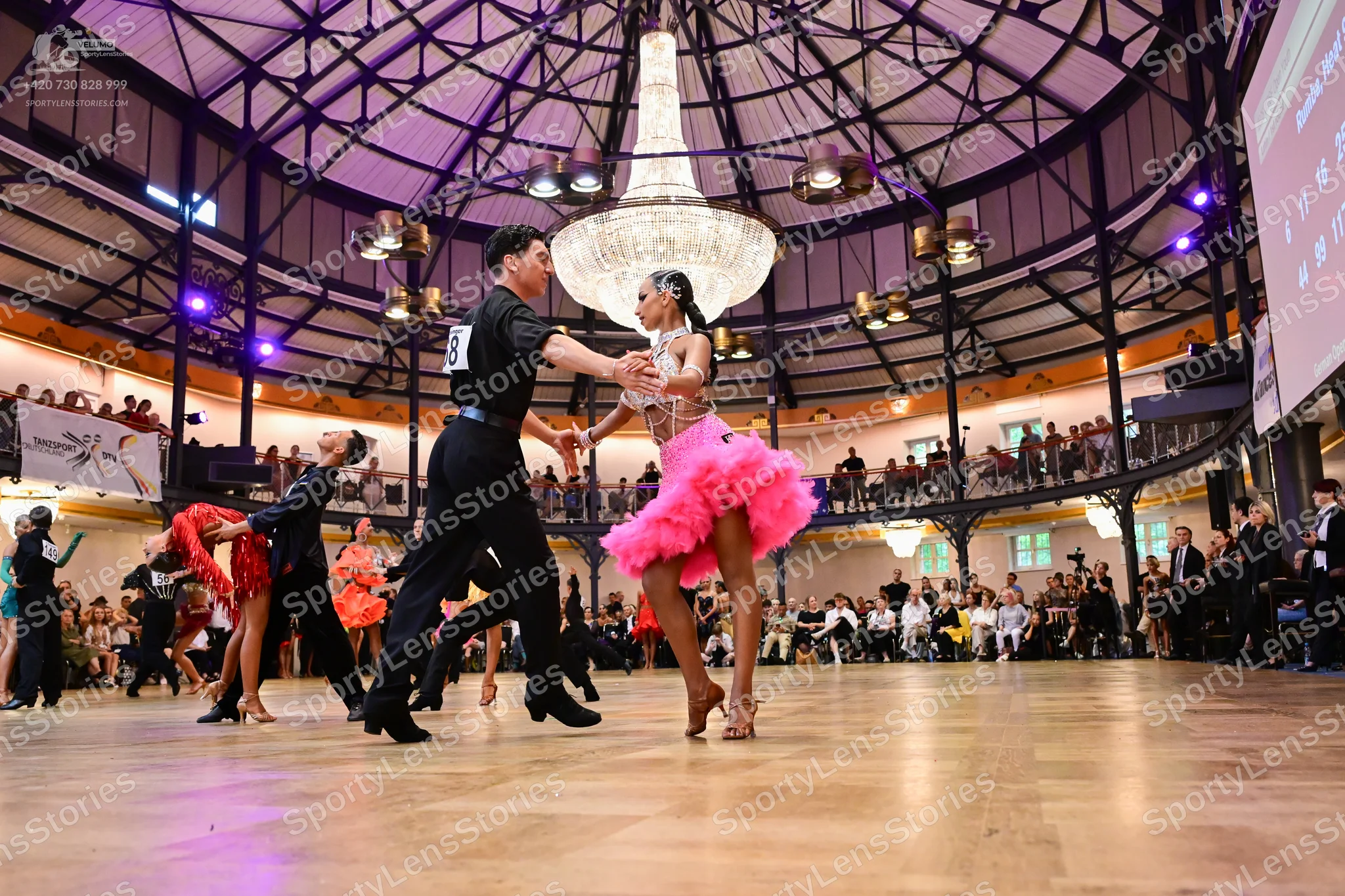 Dancesport competitor #17: Male dancer in foreground: black short-sleeved shirt and black trousers