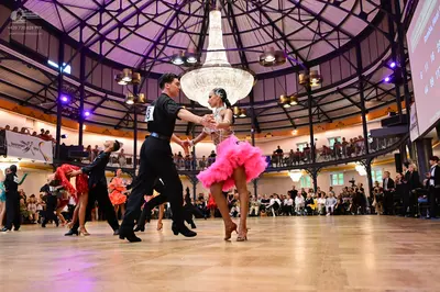 Dancesport competitor #17: Male dancer in foreground: black short-sleeved shirt and black trousers