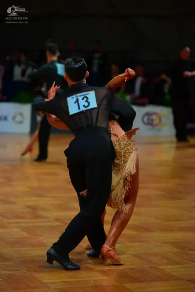 Dancesport competitor #13: Male dancer: black long-sleeved sheer shirt and black trousers