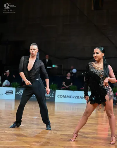 Dancesport competitor: Male dancer: black long-sleeved shirt with a deep V-neck and black trousers