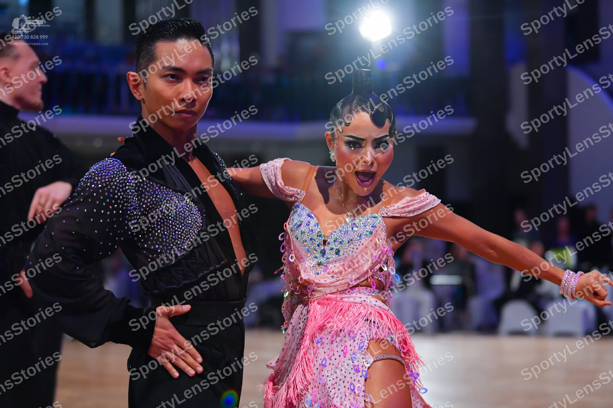Dancesport competitor: Male dancer: black Latin dance top with silver sequins and black trousers