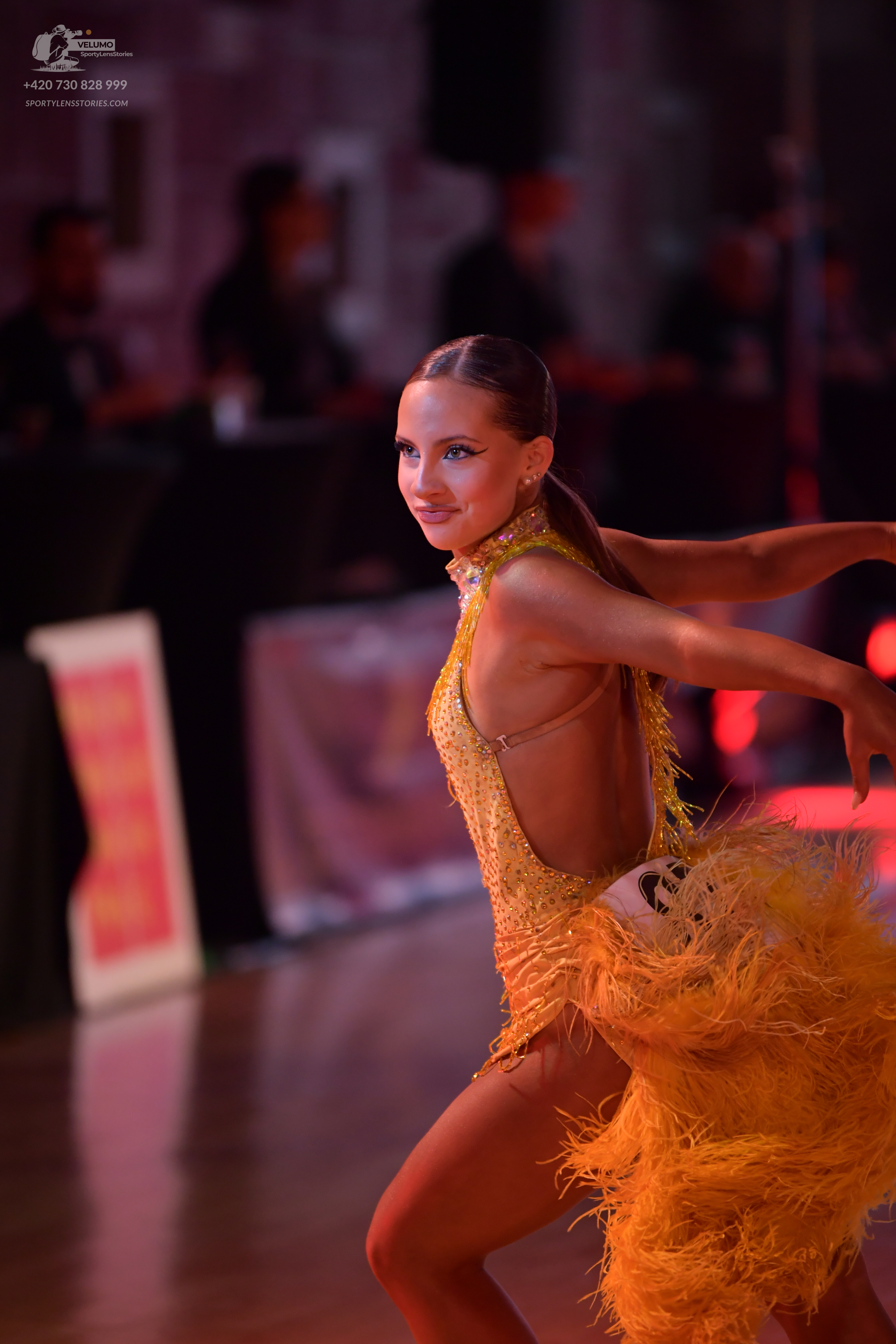 Dancesport competitor #76: Female dancer: yellow/gold Latin dress with sequins and heavy fringe/feathers