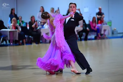 Dancesport competitor: Male dancer: black suit with white shirt and white pocket square