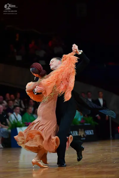 Dancesport competitor: Male dancer: black suit, white shirt, and black trousers