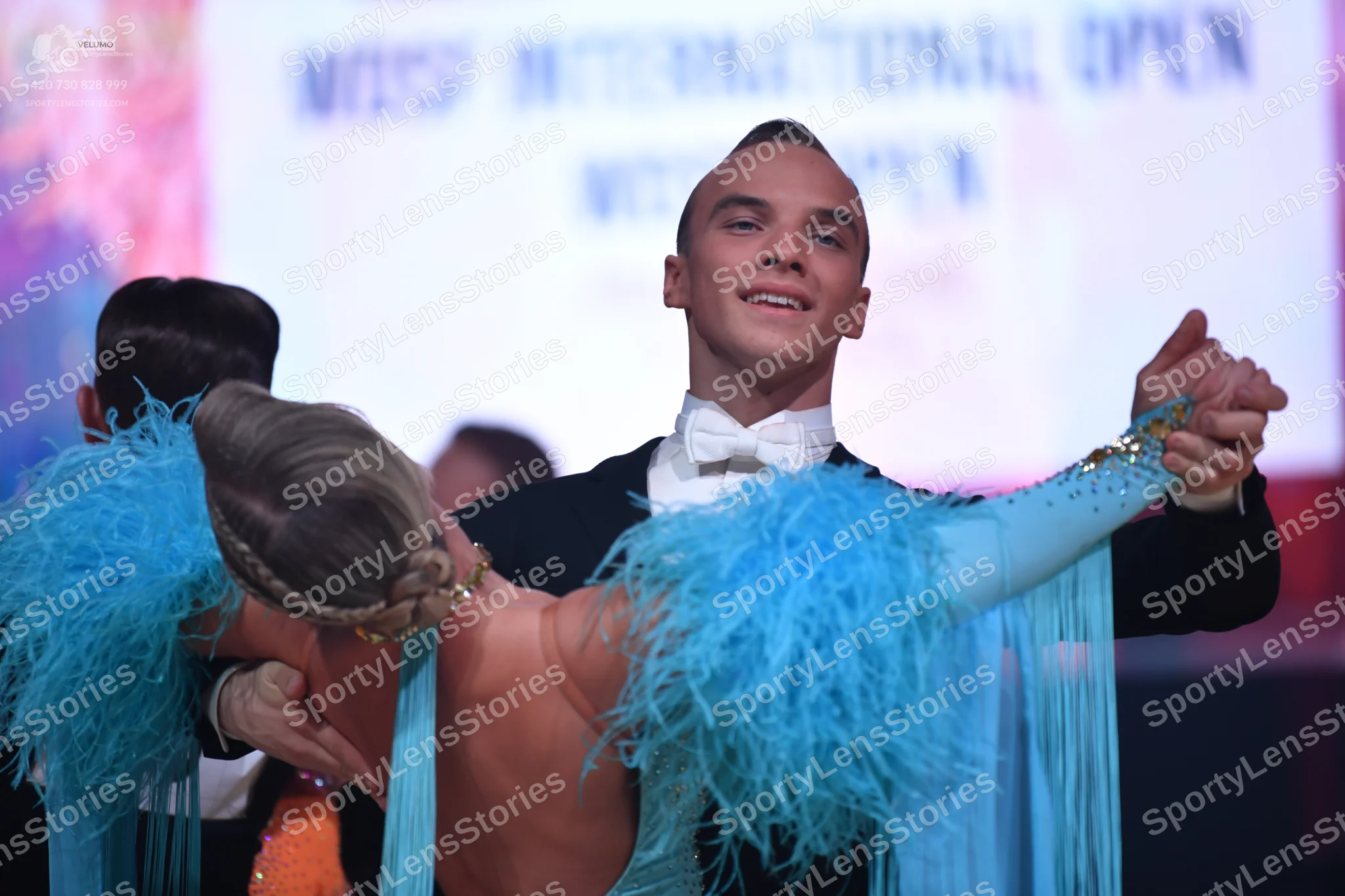 Dancesport competitor: Male dancer: black suit with a white shirt and white bow tie