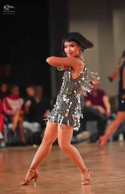 Dancesport competitor #329: Female dancer: black latin dress with silver sequins and long silver fringe, pai