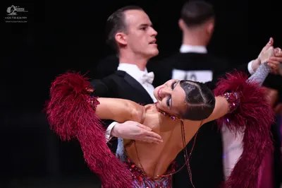Dancesport competitor: Male dancer: black suit with a white shirt and white bow tie