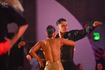 Dancesport competitor: Male dancer: black long-sleeved shirt and black trousers