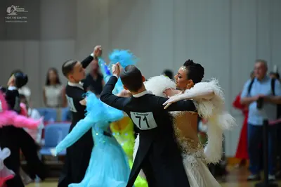 Dancesport competitor #71: Male dancer in foreground: black suit