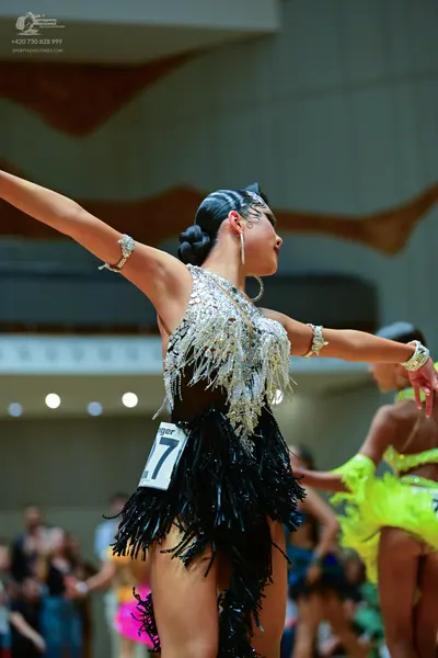 Dancesport competitor #27: Female dancer in foreground: black and silver latin dress with silver sequins/cr