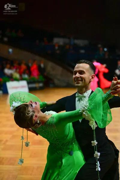 Dancesport competitor: Male dancer: black suit with a white shirt and white bow tie