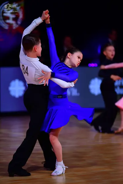 Dancesport competitor: Male dancer: white long-sleeved shirt and black trousers