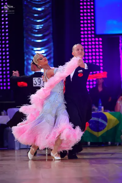 Dancesport competitor #391: Female dancer: light blue ballroom gown with a voluminous pink feathered skirt a
