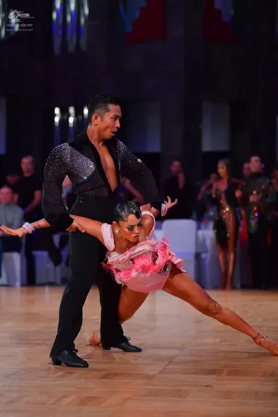 Dancesport competitor: Male dancer: black long-sleeved Latin dance shirt with sequins on the upper ches