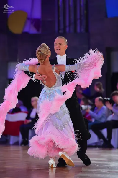 Dancesport competitor: Male dancer: black suit with a white shirt and white bow tie