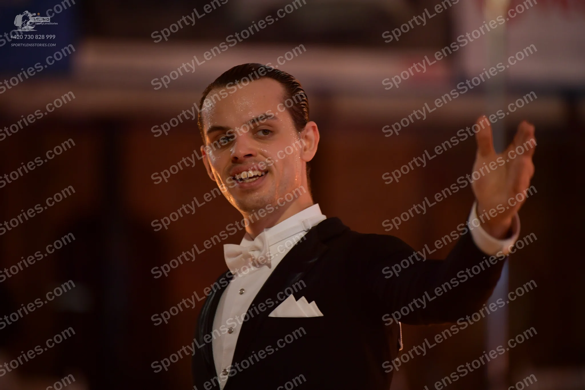 Dancesport competitor: Male dancer: black suit with a white shirt, white bow tie, and a white pocket sq