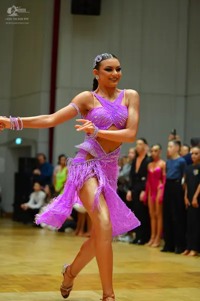Dancesport competitor: Female dancer: lavender latin dance dress with sequins and fringe, featuring a c