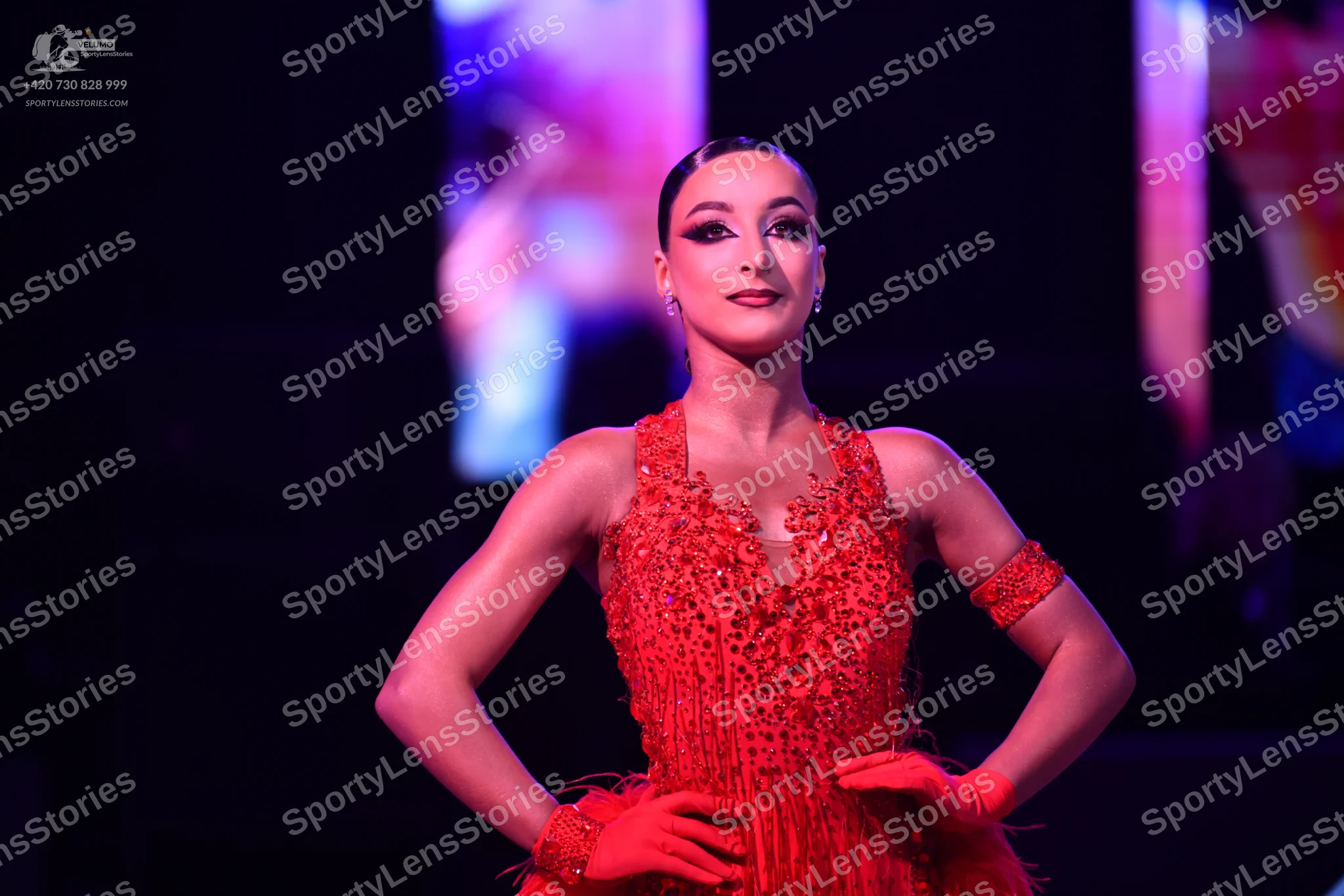 Dancesport competitor: Female dancer: red Latin dress with intricate red sequin and bead embellishments