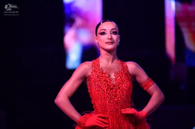 Dancesport competitor: Female dancer: red Latin dress with intricate red sequin and bead embellishments