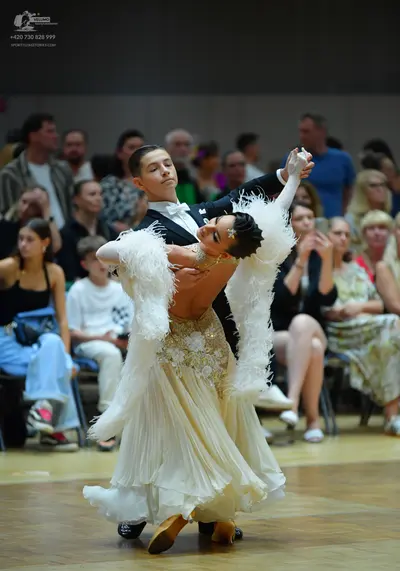 Dancesport competitor: Male dancer: black tuxedo with a white shirt and white bow tie