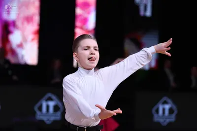 Dancesport competitor: Male dancer: white long-sleeved shirt and black trousers with a belt