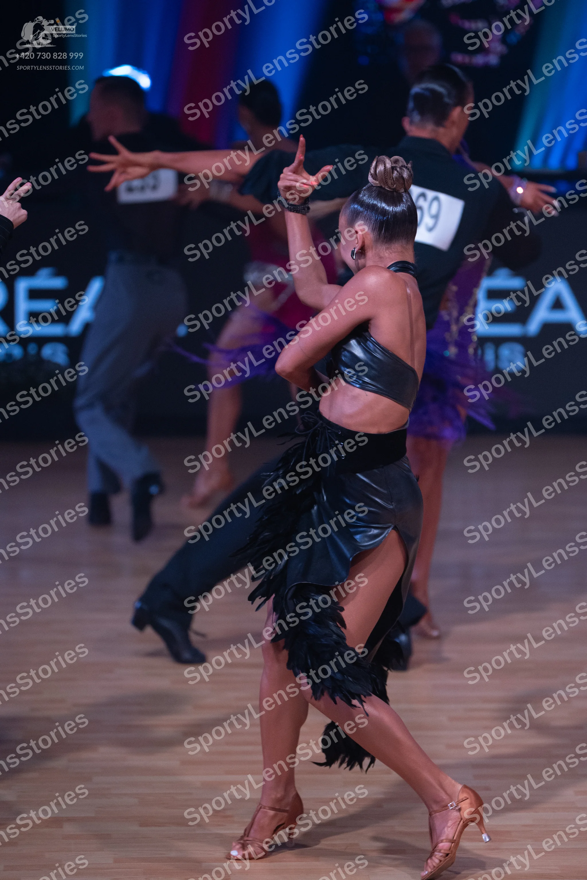 Dancesport competitor: Male dancer: black long-sleeve shirt and grey trousers