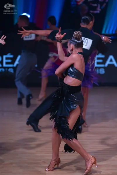 Dancesport competitor: Male dancer: black long-sleeve shirt and grey trousers